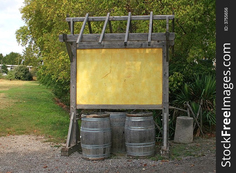 Empty board and wine barrels on a wineyard. South France. Empty board and wine barrels on a wineyard. South France