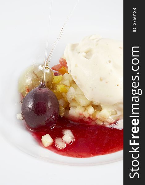 Dessert of fruits and ice cream with sauce of strawberry