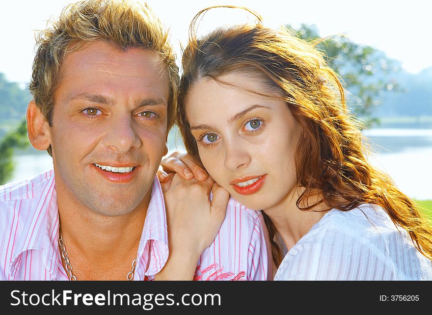 A portrait of attractive couple in summer environment. A portrait of attractive couple in summer environment