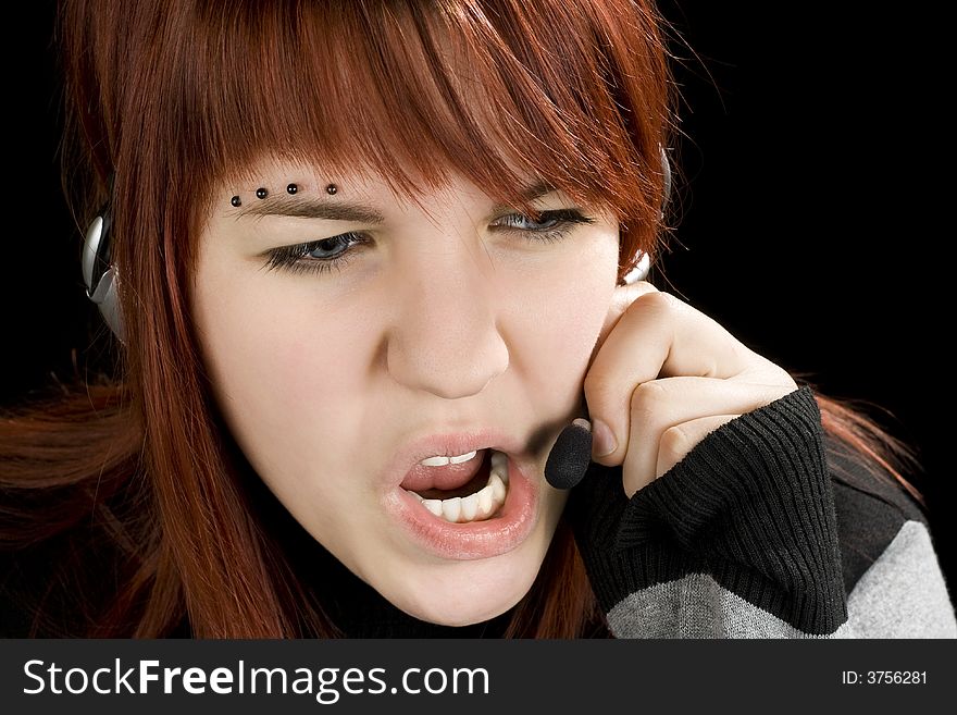 A redhead girl swearing on the microphone talking to a customer or being unpolite and stressed. Studio shot. A redhead girl swearing on the microphone talking to a customer or being unpolite and stressed. Studio shot.