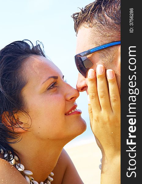 A portrait of attractive couple having fun on the beach. A portrait of attractive couple having fun on the beach