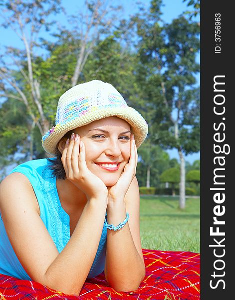 Portrait of young beautiful woman in colorful hat in summer environment. Portrait of young beautiful woman in colorful hat in summer environment