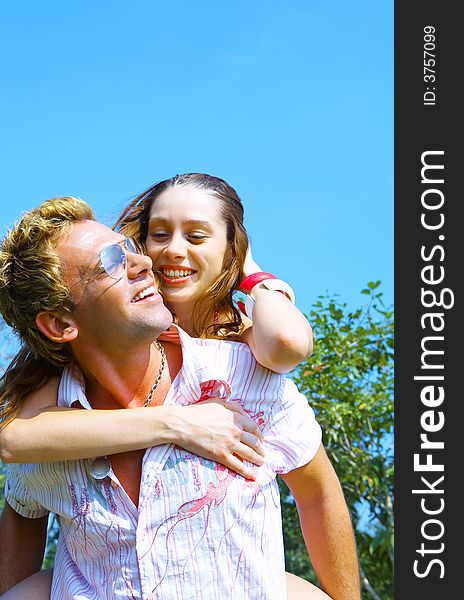 a portrait of attractive couple in summer environment. a portrait of attractive couple in summer environment