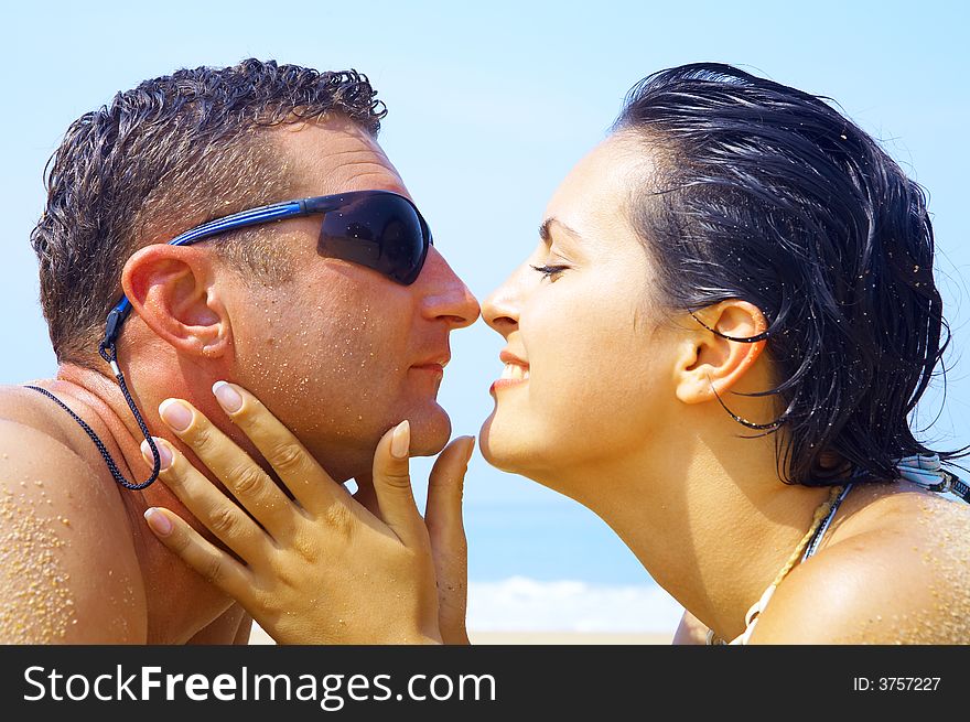 A portrait of attractive couple having fun on the beach. A portrait of attractive couple having fun on the beach