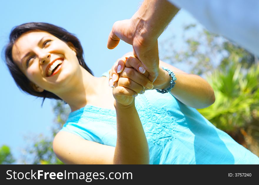 A portrait of attractive couple in summer environment. Focused on fingers. A portrait of attractive couple in summer environment. Focused on fingers.