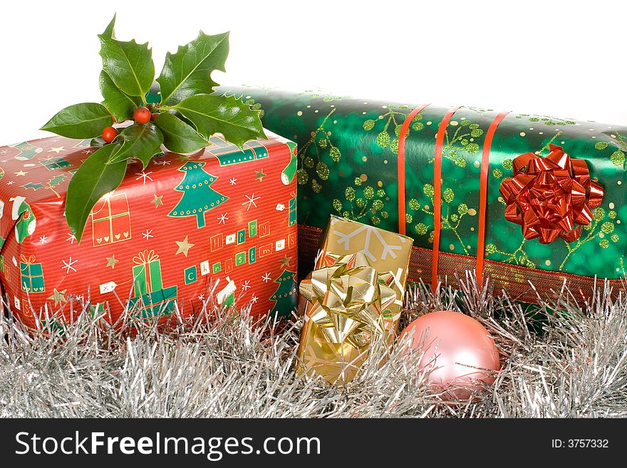 Christmas gifts, presents, wrapped with decorative stars and ribbons, ilex,holly on top of it. Christmas gifts, presents, wrapped with decorative stars and ribbons, ilex,holly on top of it