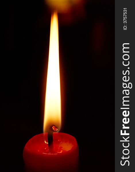 Lighting red candle with dark background. Lighting red candle with dark background
