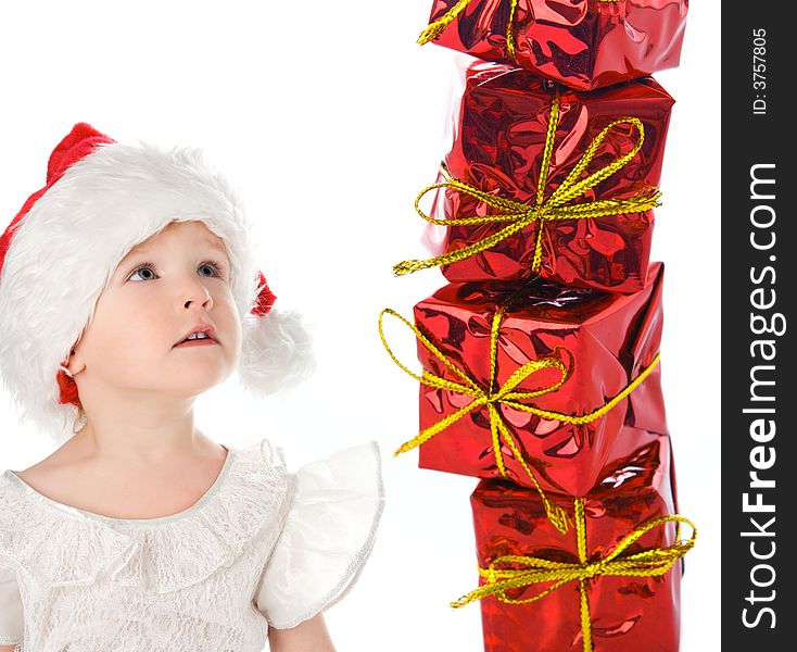 Baby in red hat with box gift over white background