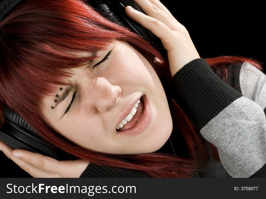 Girl Holding Headphones And Singing