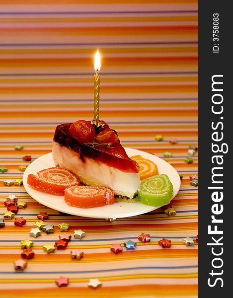 Cake, candle and stars on a stripy background. Cake, candle and stars on a stripy background