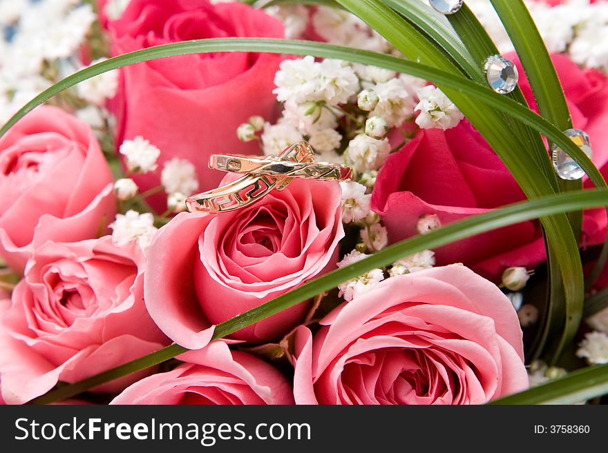 Gold rings and rose bouquet