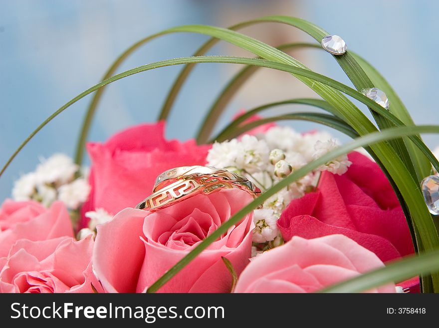 Gold rings and beautiful rose bouquet. Gold rings and beautiful rose bouquet