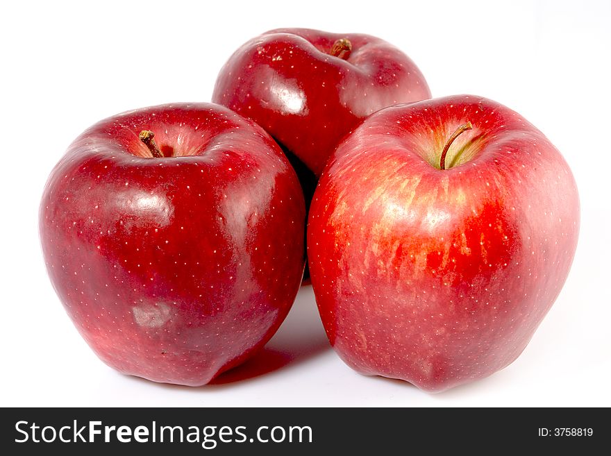 Three red apples on white background.