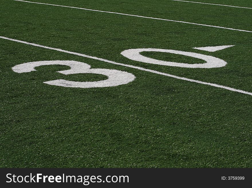 30 yard line in vivid detail at a football stadium. 30 yard line in vivid detail at a football stadium.