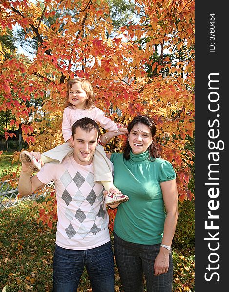 Baby on father`s shoulders with mother in the park. Baby on father`s shoulders with mother in the park