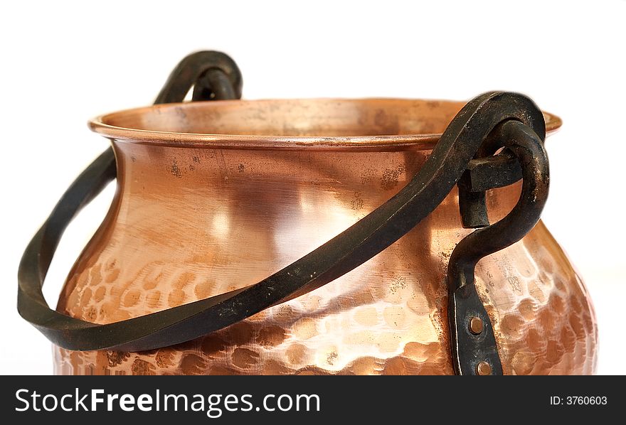 Macro close-up of brass pot isolated with white background