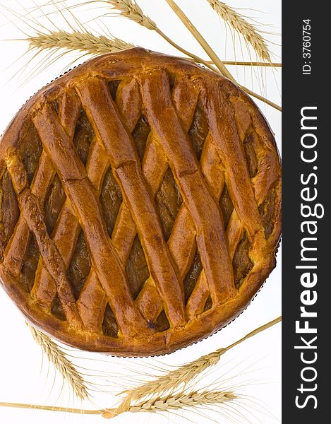 A pie with dried apricots and ears