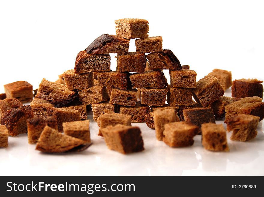 Rye bread croutons wall over white background