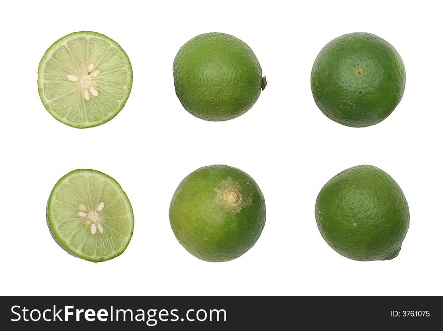 Green limes with one halved isolated on white background