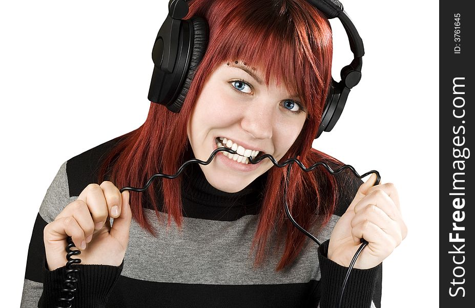 Cute girl with red hair biting the cord of her headphones while listening to music.

Studio shot. Cute girl with red hair biting the cord of her headphones while listening to music.

Studio shot.