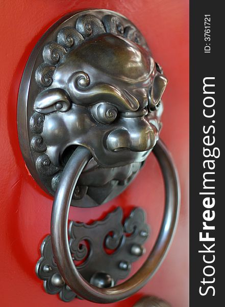 A temple door handle made of metal.