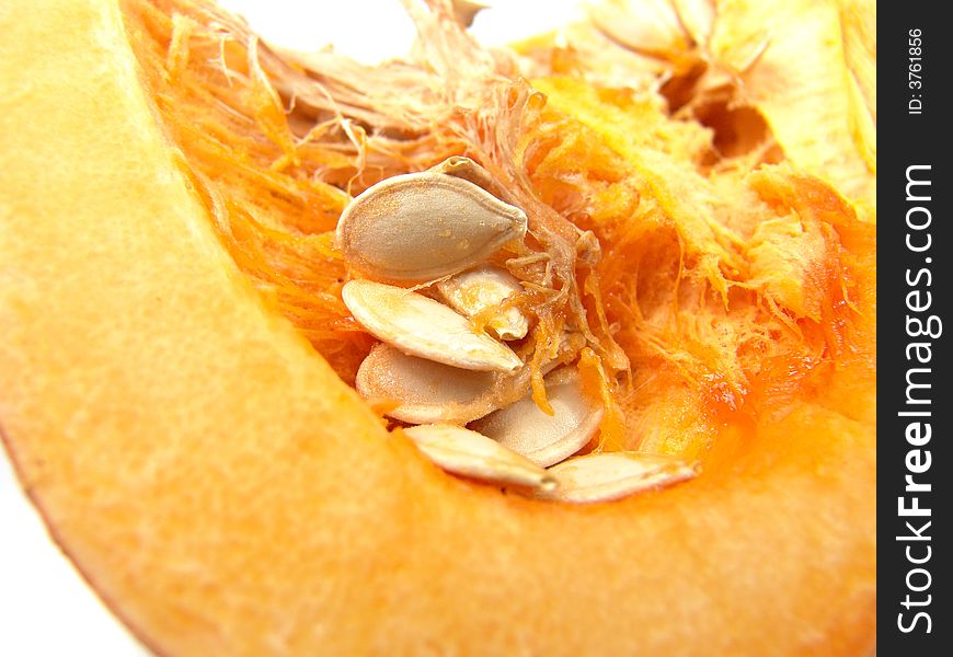 Isolated orange pumpkin with seeds macro close-up. Isolated orange pumpkin with seeds macro close-up