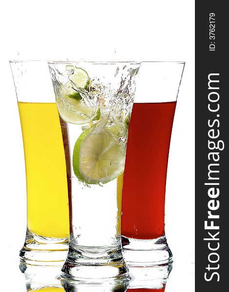 Glasses with juice and lemon on the white background