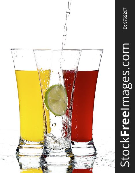 Glasses with juice and lemon on the white background