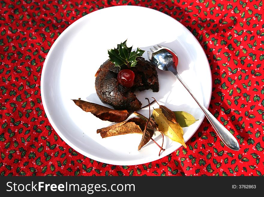 A delicious cherry sits on a Christmas Pudding. A delicious cherry sits on a Christmas Pudding