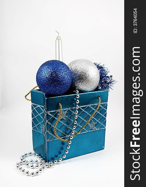 A blue bag with two balls and candle for Christmas tree isolated on white background. A blue bag with two balls and candle for Christmas tree isolated on white background