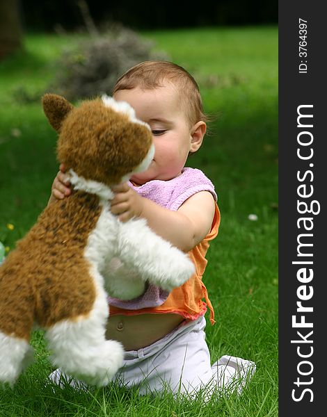 Baby playing wtih a dog in plush