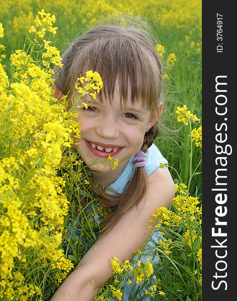 Girl at a field of yellow flowers. Girl at a field of yellow flowers