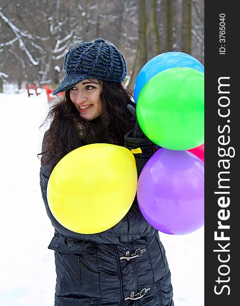 A girl holding dirrerent ballons