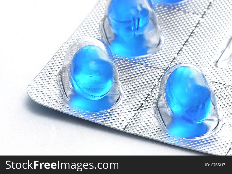 Blue pills on white background. Blue pills on white background