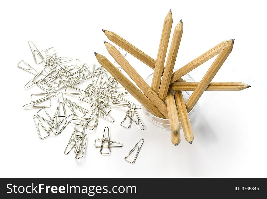 Set of the toothpicks costing in a glass on background of paper clips. Set of the toothpicks costing in a glass on background of paper clips