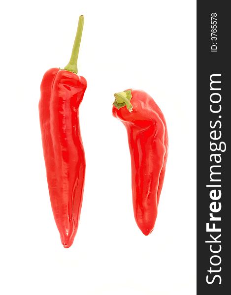 Two delicious fresh red chilli peppers isolated over white. Two delicious fresh red chilli peppers isolated over white.