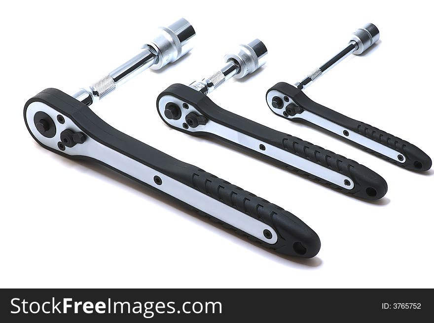 Three ratchet spanners on white background