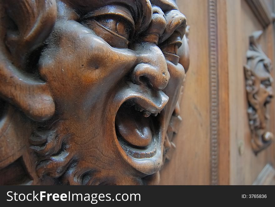 Door knocker at an old wooden door in Siena. Door knocker at an old wooden door in Siena