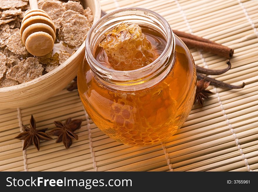 Sweet breakfast - fresh honey with honeycomb, flakes and spices