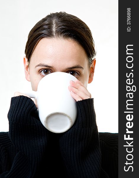 A woman on a white background enjoying a hot drink. A woman on a white background enjoying a hot drink