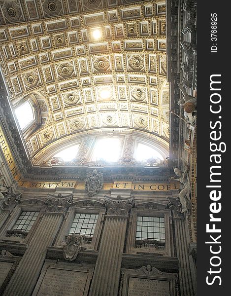 Interior of St.Pier cathedral dome with sun light coming from roof window. Vatican, Italy, EU