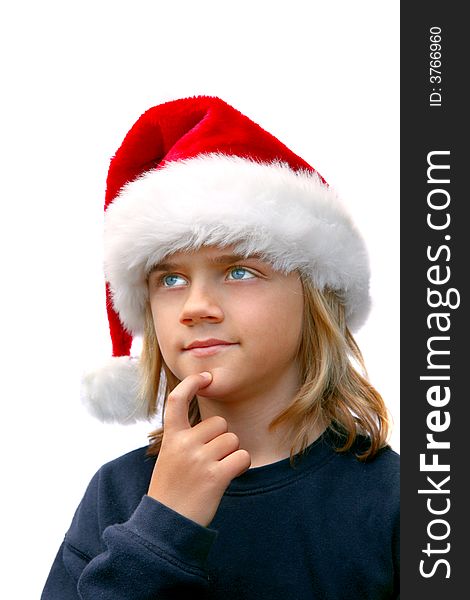 Young boy in santa hat thinking of christmas list. Young boy in santa hat thinking of christmas list.