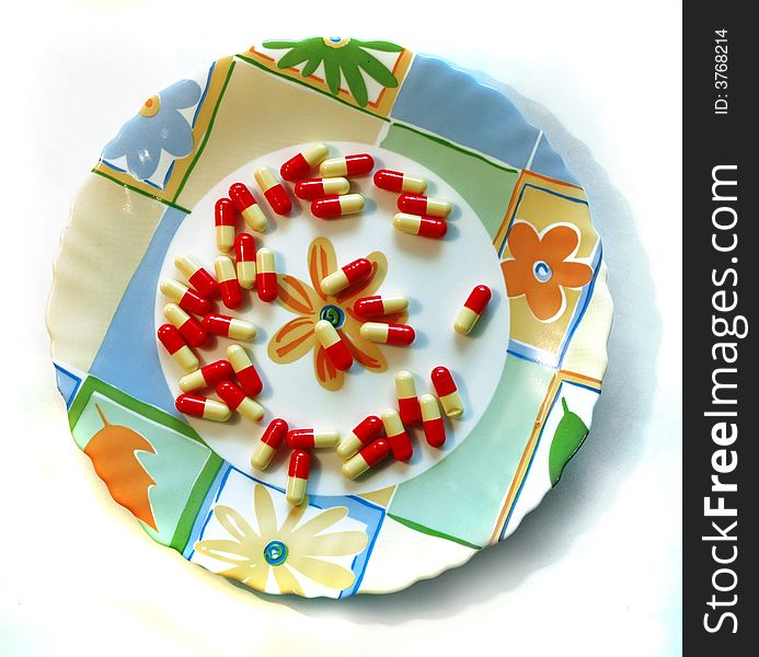 Tablets on a plate on a white background