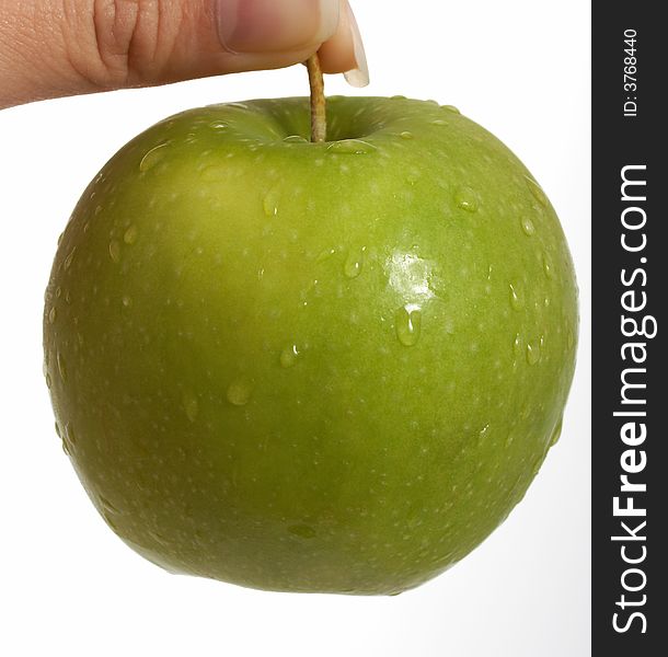 Holding a fresh green apple over a white background. Holding a fresh green apple over a white background