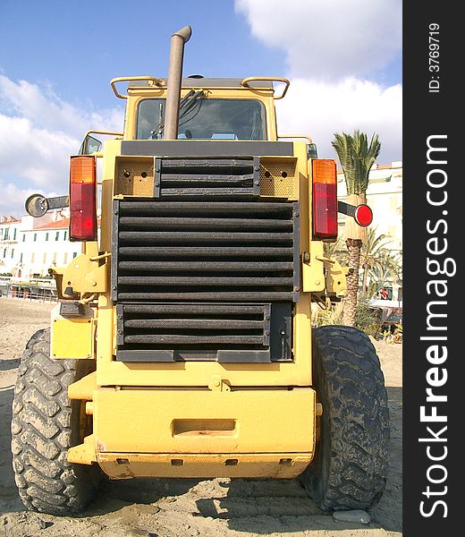 An orange digger on the beach