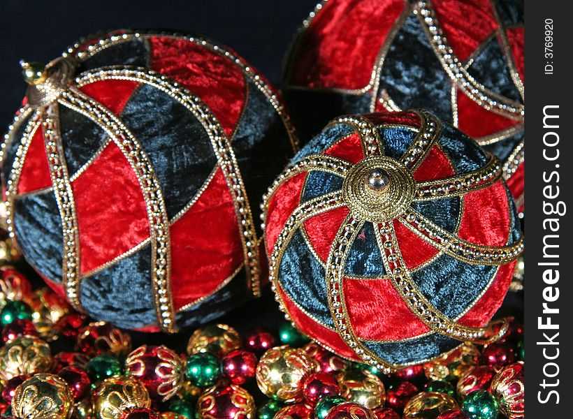 Composition of three big christmas balls and some small balls spread in the lower part of the picture