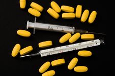 Yellow Pills, Syringe And Thermometer Stock Photo Yellow Pills, Syringe And Thermometer Stock Photo