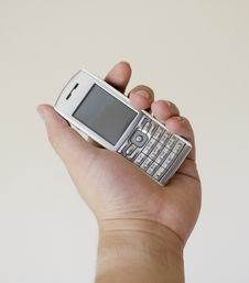 Mobile Phone On Left Hand Stock Image