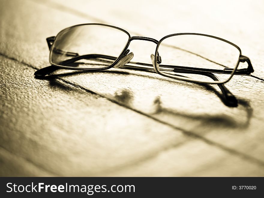 Still life of a pair of spectacles on a textured background