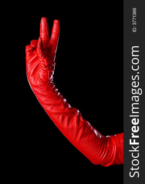 Hand in red glove on the black background counting two. Hand in red glove on the black background counting two